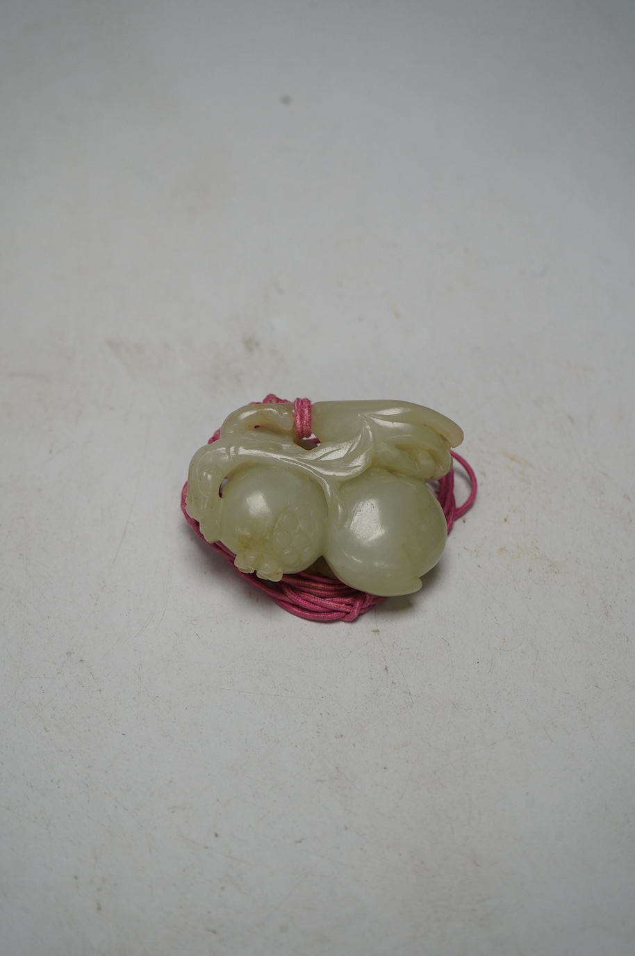 A 19th century jade carving of fruit, 5.5cm wide. Condition - fair, a small piece missing